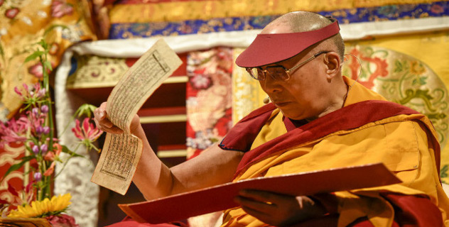 His Holiness the Dalai Lama holding the Tibetan text during the afternoon session of his teachings in Hamburg, Germany on August 25, 2014. Photo/Manuel Bauer
