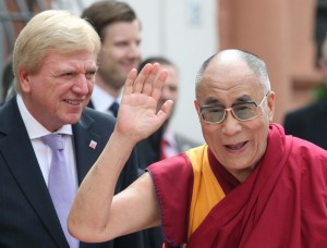 Tibetan spiritual leader the Dalai Lama waves next to Hesse's state Prime Minister Bouffier during a visit to the monastery in Seligenstadt
