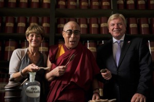 Tibetan spiritual leader Dalai Lama Hesse's state Prime Minister Bouffier and his wife Ursula pose in a pharmacy during a visit to monastery in Seligenstadt