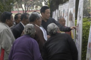 Tibet Museum staff Tenzing Ramjam expalining the photo Exhibition at Dekyiling Tibetan Settlement on 7th March 2012 (1)