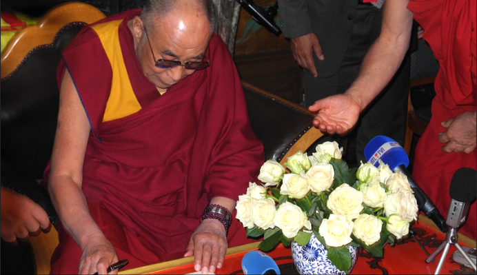 His Holiness the Dalai Lama signing the certificates proclaiming him an honorary citizen of the city of Huy at Yeunten Ling Institute in Huy, Belgium, on 24 May 2012/Photo/Jeremy Russell/OHHDL