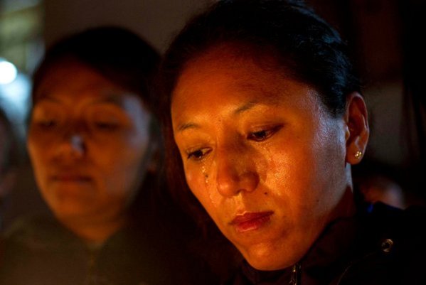 A Tibetan exile shed tears during a candlelit vigil in Dharmsala, India Sunday. Attendees expressed solidarity with a young Tibetan who set fire to himself in protest of China, earlier that morning/Photo/Ashwini Bhatia/Associated Press