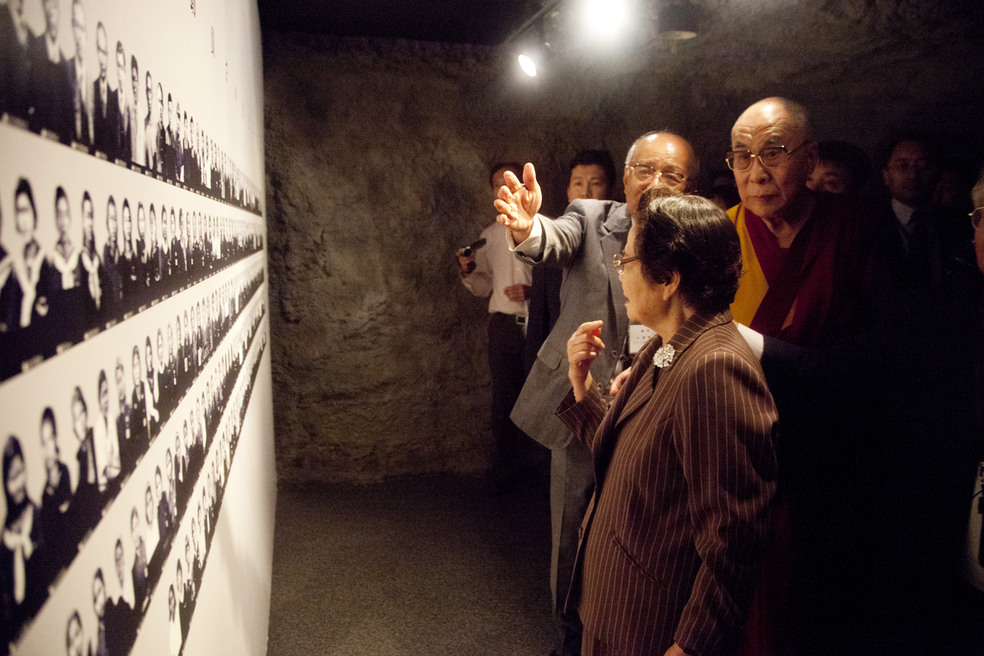 His Holiness the Dalai Lama glancing at pictures taken during the second world war at the Himeyuri war museum.