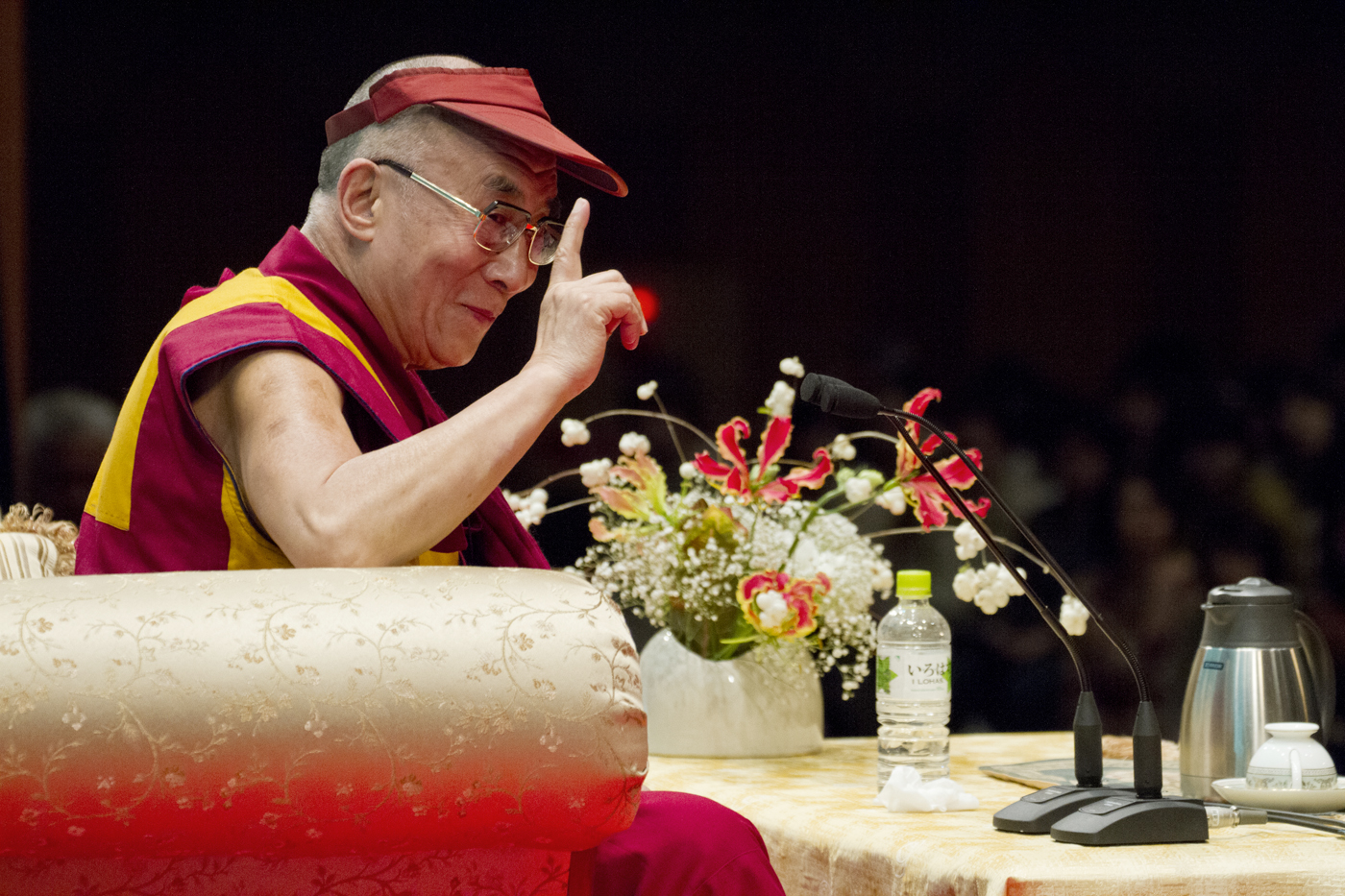 His Holiness the Dalai Lama responding to a question posed by an audience during his talk at the Kenritsu Budo hall in Okinawa, Japan