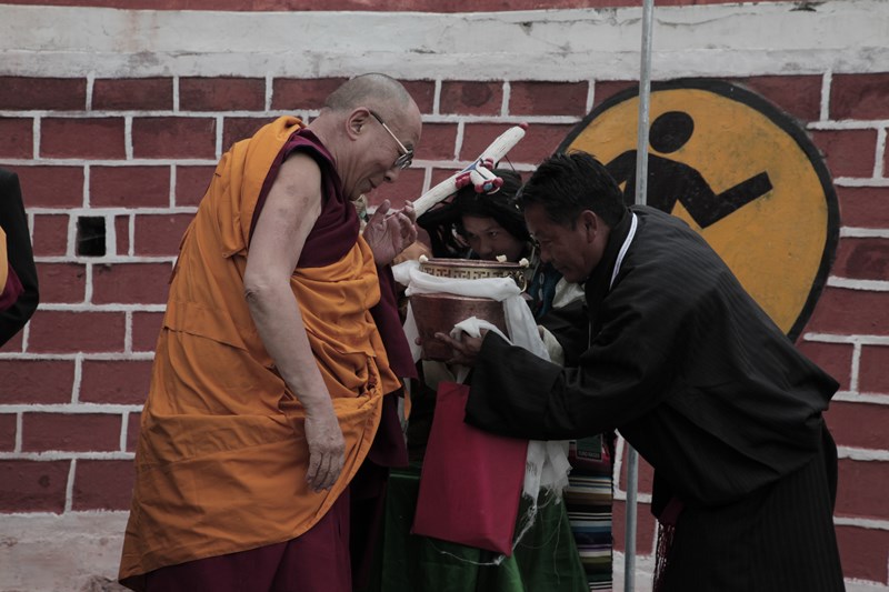 A school official and student welcome His Holiness the Dalai Lama as he arrives to give a short teaching as part of the golden jubilee celebrations of the CST school at Dalhousie, India, on 27 April 2013/Photo/Sangjey Kyab