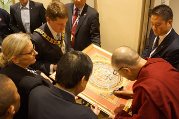 His Holiness the Dalai Lama signing a framed mandala for Adelaide Lord Mayor Stephen Yarwood during his visit to the Adelaide Town Hall in Adelaide, Australia on June 21, 2013. Photo/Jeremy Russell/OHHDL