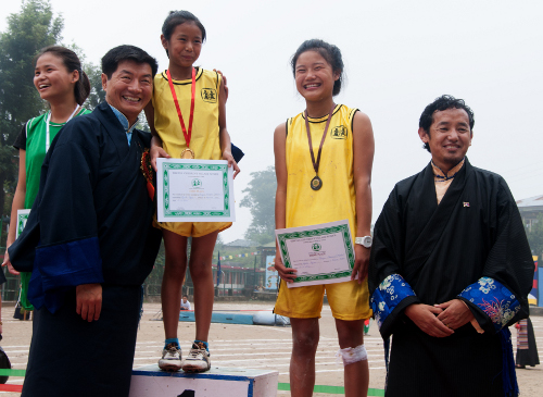 Sikyong posing with the winners of 80 metre sprint after presenting their awards.