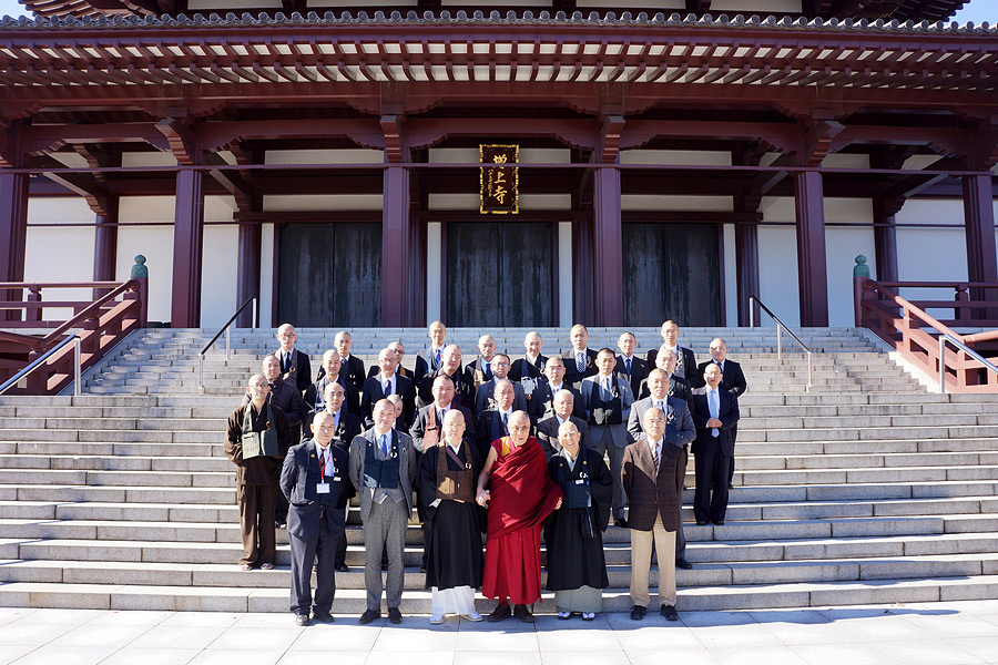 His Holiness the Dalai Lama poses on the temple steps with priests and members of the Zojoji Temple in Tokyo, Japan on November 19, 2013. Photo/Jeremy Russell/OHHDL