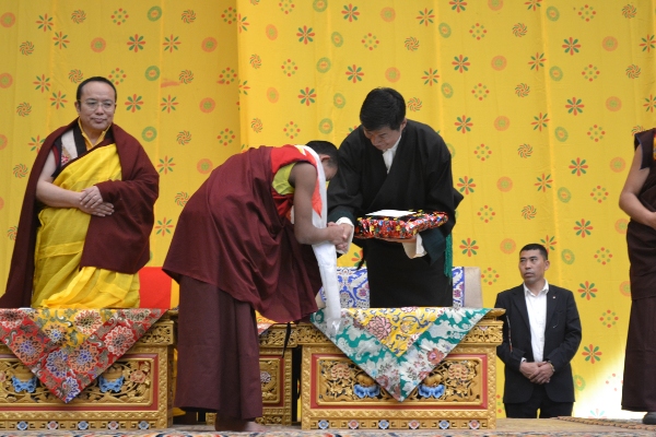 Sikyong Dr Lobsang Sangay doing the honours of awarding a merit student of the monastery.