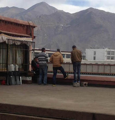 A view of policemen in plainclothes deployed on the rooftops of a temple in Lhasa, the capital of Tibet