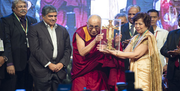His Holiness the Dalai Lama is presented a memento at the start of the opening session of the Association of Heads of Anglo-Indian Schools in India's 92nd Annual Conference at Bishop Cotton School in Bangalore, India on January 5, 2014. Photo/Tenzin Choejor/OHHDL