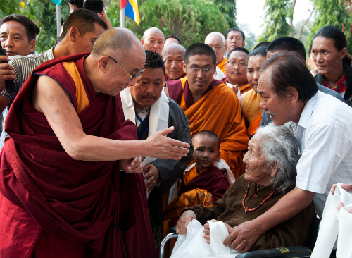 An old Tibetan woman at His Holiness the Dalai Lama's arrival at Norgyeling settlement.