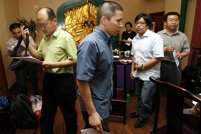 Xu Zhiyong, center, was indicted last month for “gathering a crowd to disrupt public order” and faces almost certain conviction. Greg Baker/Associated Press