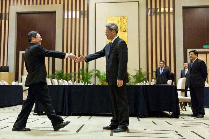 Wang Yu-chi, (left), head of Taiwan's Mainland Affairs Council, and Zhang Zhijun, head of China’s Taiwan Affairs Office, greeted each other before their meeting on Tuesday in Nanjing, China/Photo by Alexander F. Yuan/Associated Press