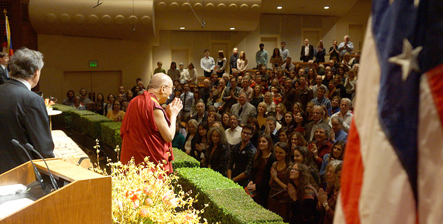 His Holiness the Dalai Lama greets the audience before his talk at Davies Symphony Hall in San Francisco, California on February 22, 2014. Photo/American Himalayan Foundation