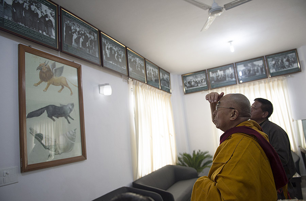 His Holiness the Dalai Lama looking a photos of previous Tibetan parliamentarians during his visit to the newly reconstructed Tibetan Parilament-in-Exile building in Dharamsala, India on March 11, 2014. Photo/Tenzin Choejor/OHHDL
