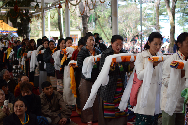 Tibetans carrying scriptures during the long life prayer ceremony