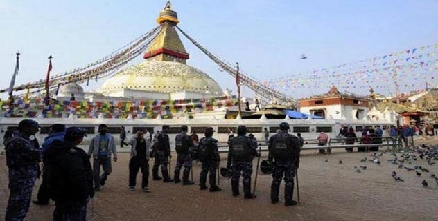Nepalese police in riot gear keep watch at the Boudhanath Stupa during the 54th anniversary of the 1959 Tibetan uprising against Chinese rule, in Kathmandu on 10 March 2013.