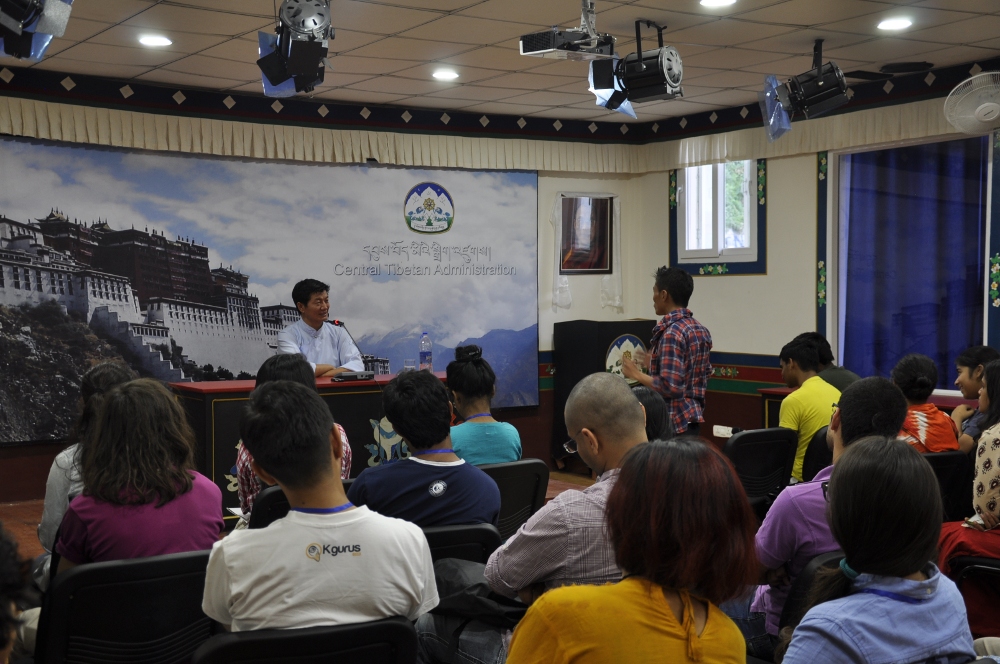 A student posing a question to Sikyong Dr. Lobsang Sangay during the interaction.