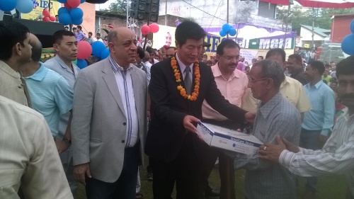 Sikyong Dr.Lobsang Sangay distributing smart canes for the blind and visually impaired, at the fair on 27 July 2014.