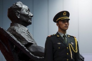 A soldier of the People's Liberation Army stands guard in front of a statue of the late Chinese leader Deng Xiaoping at an exhibition commemorating the 110th anniversary of his birth, in Hong Kong, on August 21,2014/Reuters photo
