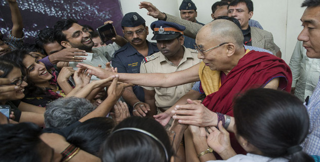 His Holiness the Dalai Lama reaching out to shake hands with well-wishers as he departs from the Tata Institute of Social Sciences in Mumbai, India on September 17, 2014. Photo/Tenzin Choejor/OHHDL