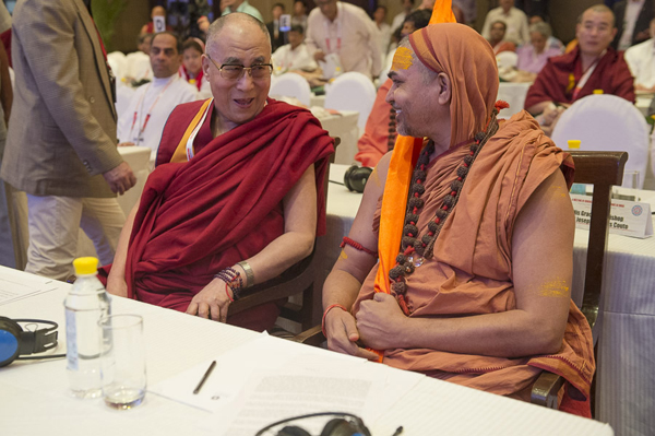 His Holiness the Dalai Lama with Swami Avimukteshwaranand Saraswati before the 1st Plenary Session on Inter-Religious Understanding and Human Values on the first day of the two day 'Meeting of Diverse Spiritual Traditions in India' in New Delhi, India on September 20, 2014. Photo/Tenzin Choejor/OHHDL