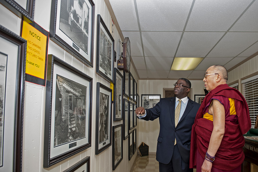 His Holiness the Dalai Lama looks at photos of historic events in the Civil Rights� struggle in the Memorial Room of the 16th Street Baptist Church, Birmingham, Alabama, USA, October 25, 2014. Photo/Liesa Cole