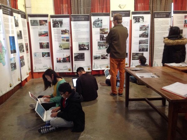 Students taking notes from the Tibet Museum's exhibition panels on Tibet and His Holiness the Dalai Lama.