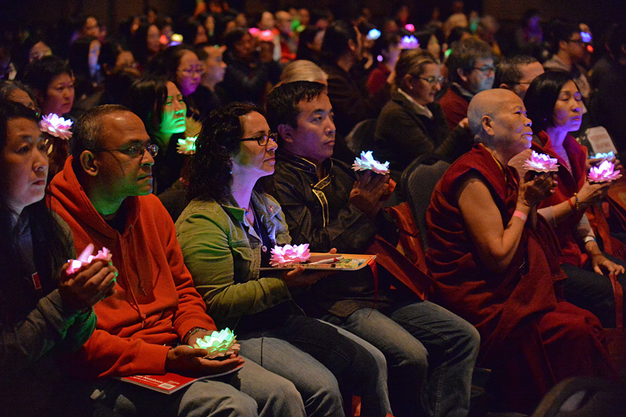 Members of the audience holding lighted lotus petals as an offering during His Holiness the Dalai Lama's teachings at the Manhattan Center in New York City on November 2, 2014. Photo/Sonam Zoksang