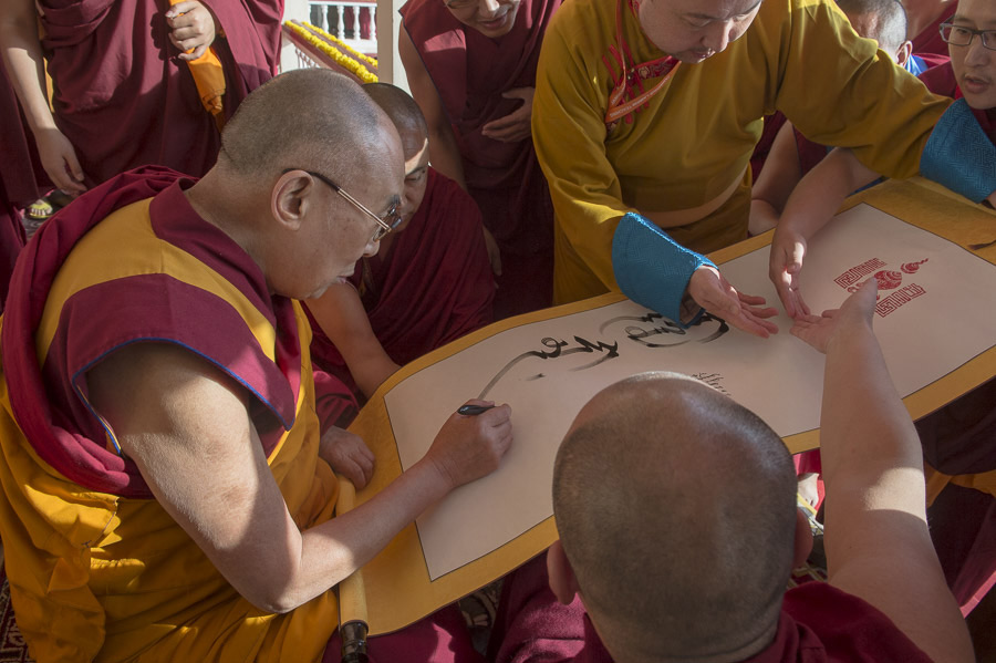 His Holiness the Dalai Lama signing a special proclamation during the inauguration of the new hostel for students from Mongolian regions at Drepung Gomang Monastery in Mundgod, Karnataka, India on December 25, 2014. Photo/Tenzin Choejor/OHHDL
