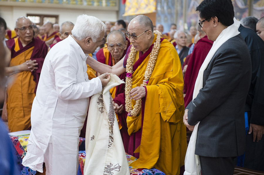 Karnataka Minister of Higher Education and Tourism R.V. Deshpande presenting His Holiness the Dalai Lama with a shawl at the start of ceremonies commemorating his first teaching in exile at Tawang 55 years ago at Ganden Jangtse Monastery in Mundgod, Karnataka, India on December 26, 2014. Photo/Tenzin Choejor/OHHDL