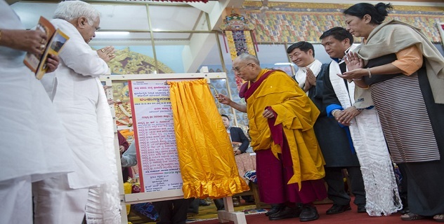 His Holiness the Dalai Lama unveils a plaque launching a project by the Karnataka Ministry of Tourism to aid visitors to the Tibetan settlements during ceremonies commemorating his first teaching in exile at Tawang 55 years ago at Ganden Jangtse Monastery in Mundgod, Karnataka, India on December 26, 2014. Photo/Tenzin Choejor/OHHDL