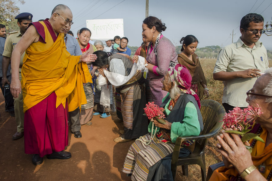 His Holiness the Dalai Lama greeting elderly Tibetans who had lined the road waiting to show their support and good wishes during his visit to Mundgod, Karnataka, India on December 28, 2014. Photo/Tenzin Choejor/OHHDL