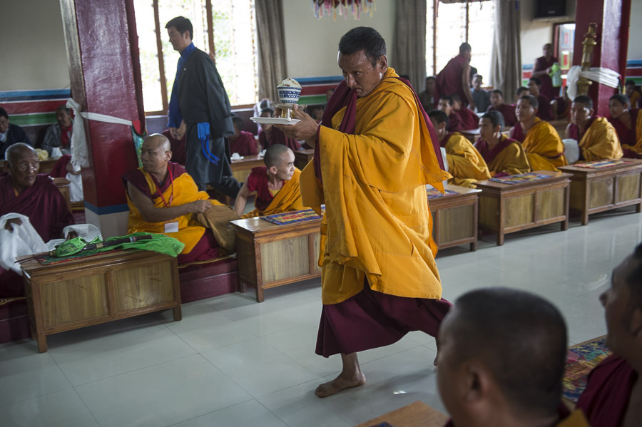 A monk bringing a traditional rice dish to offer His Holiness the Dalai Lama during his visit to Tsechen Do Ngag Choeling Sakya Monastery in Mundgod, Karnataka, India on December 29, 2014. Photo/Tenzin Choejor/OHHD