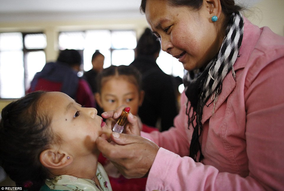 Don't move: A Tibetan girl gets makeup done for a function organised by the Tibetan Refugee Community in Nepal, commemorating the 25th Anniversary of the Nobel Peace Prize conferment to exiled Tibetan spiritual leader.