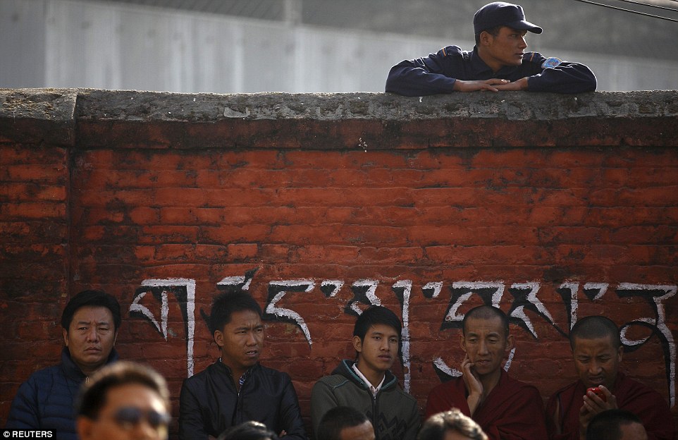 High-tech: A monk can be seen here checking his cell phone at a celebratory event marking the Dalai Lama receiving the Nobel Peace Prize.