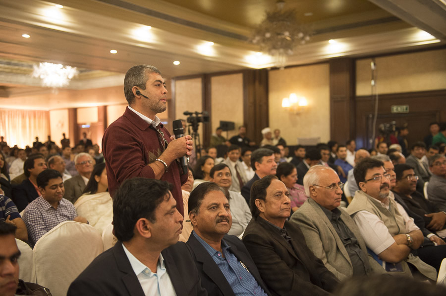A member of the audience asking His Holiness the Dalai Lama a question during his meeting with industrialists in Surat, Gujarat, India on January 2, 2015. Photo/Tenzin Choejor/OHHDL