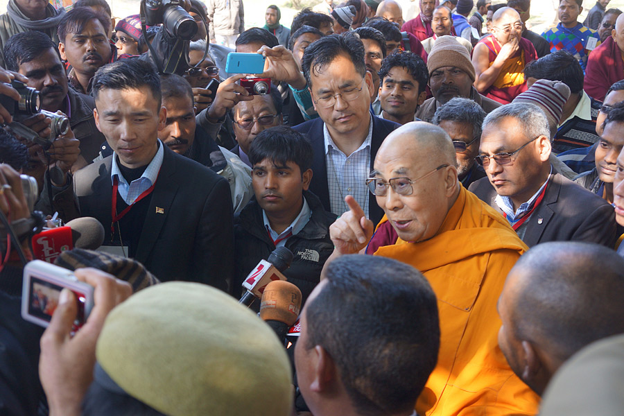 His Holiness the Dalai Lama answering questions from members of the press as he departs from the stupa in Sankisa, UP, India on January 30, 2015. Photo/Jeremy Russell/OHHDL