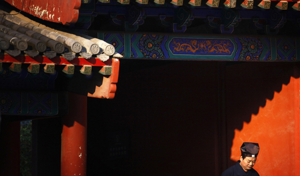 A Taoist priest stands in sunlight to keep warm in the courtyard of the 700-year-old Dongyue Temple in central Beijing. Credit: David Gray/Reuters