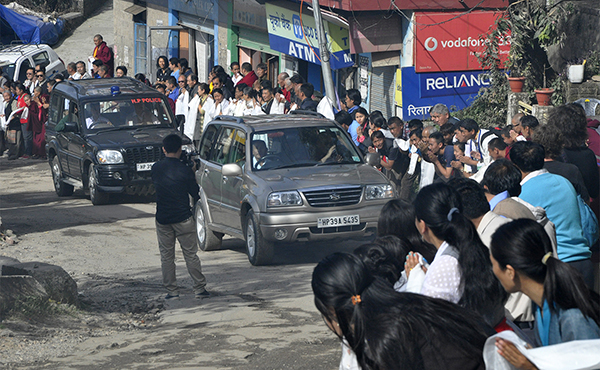 Tibetans line the streets of Gangchen Kyishong in Dharamshala, to welcome His Holiness the Dalai Lama, 26 March 2015.