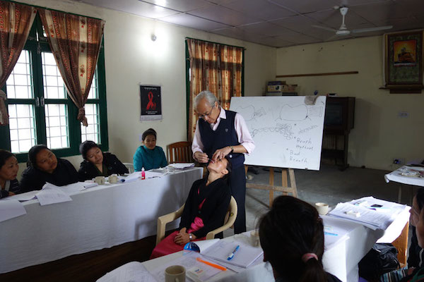 The resource person conducting a practical demonstration during the dental training