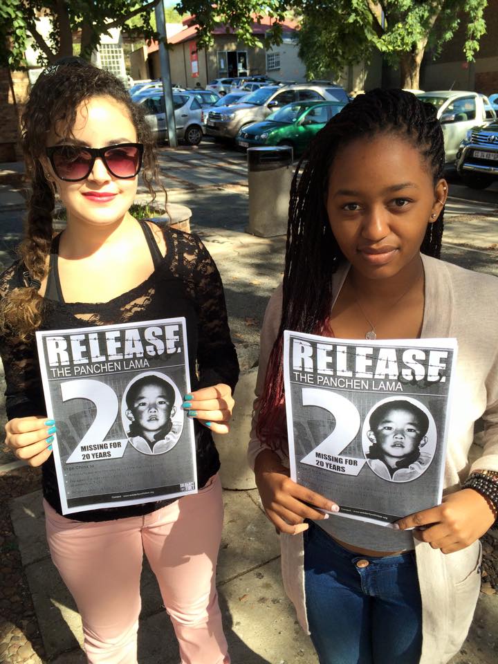 Students with pamphlets and banners calling for the release of the 11th Panchen Lama Gedhun Choekyi Nyima.