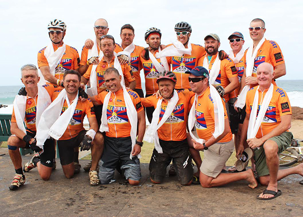 Cyclists wearing traditional Tibetan ceremonial scarves at the cycle rally.