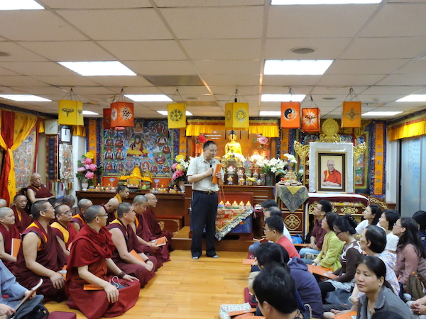 Representative Dawa Tsering expressing his sadness and condolences at the prayer service.