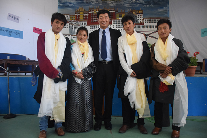 Sikyong Dr. Lobsang Sangay poses with the four students who are graduating class 12 from Sherab Gatsel Lobling.