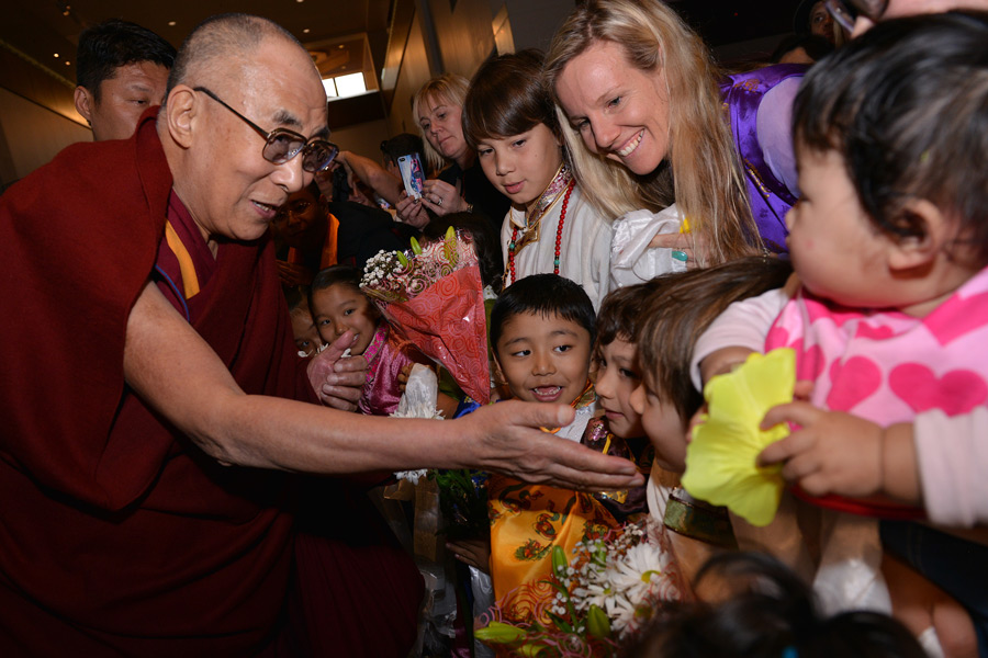 His Holiness the Dalai Lama reaches out to young children as he is welcomed on his arrival in Brisbane, Australia on June 10, 2015. Photo/Rusty Stewart
