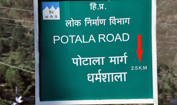 A sign board depicting Potala Road. the raod from Mcleod Ganj to Dharamshala.