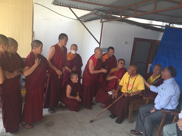 Education Kalon interacting monks during his damage assessment visit.