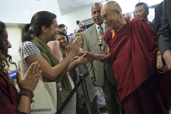 His Holiness the Dalai Lama greeting to well-wishers as he walks to the stage for the afternoon session at the University of California Irvine's Bren Center in Irvine, California on July 6, 2015. Photo/Tenzin Choejor/OHHDL